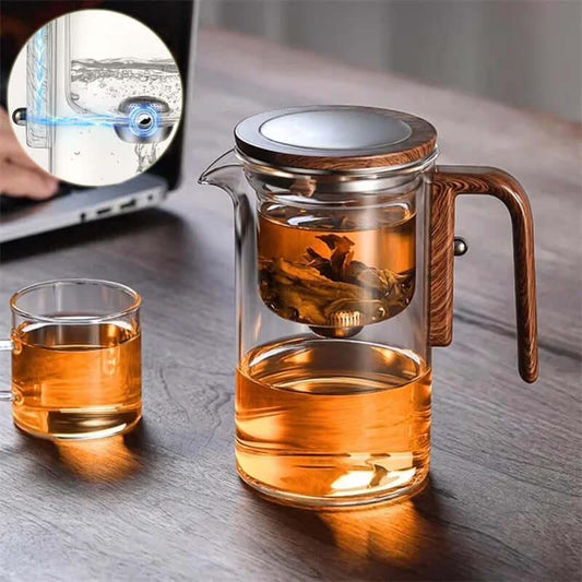 Elegant glass teapot with wooden handle, featuring innovative infuser for precise tea brewing and smooth pouring.